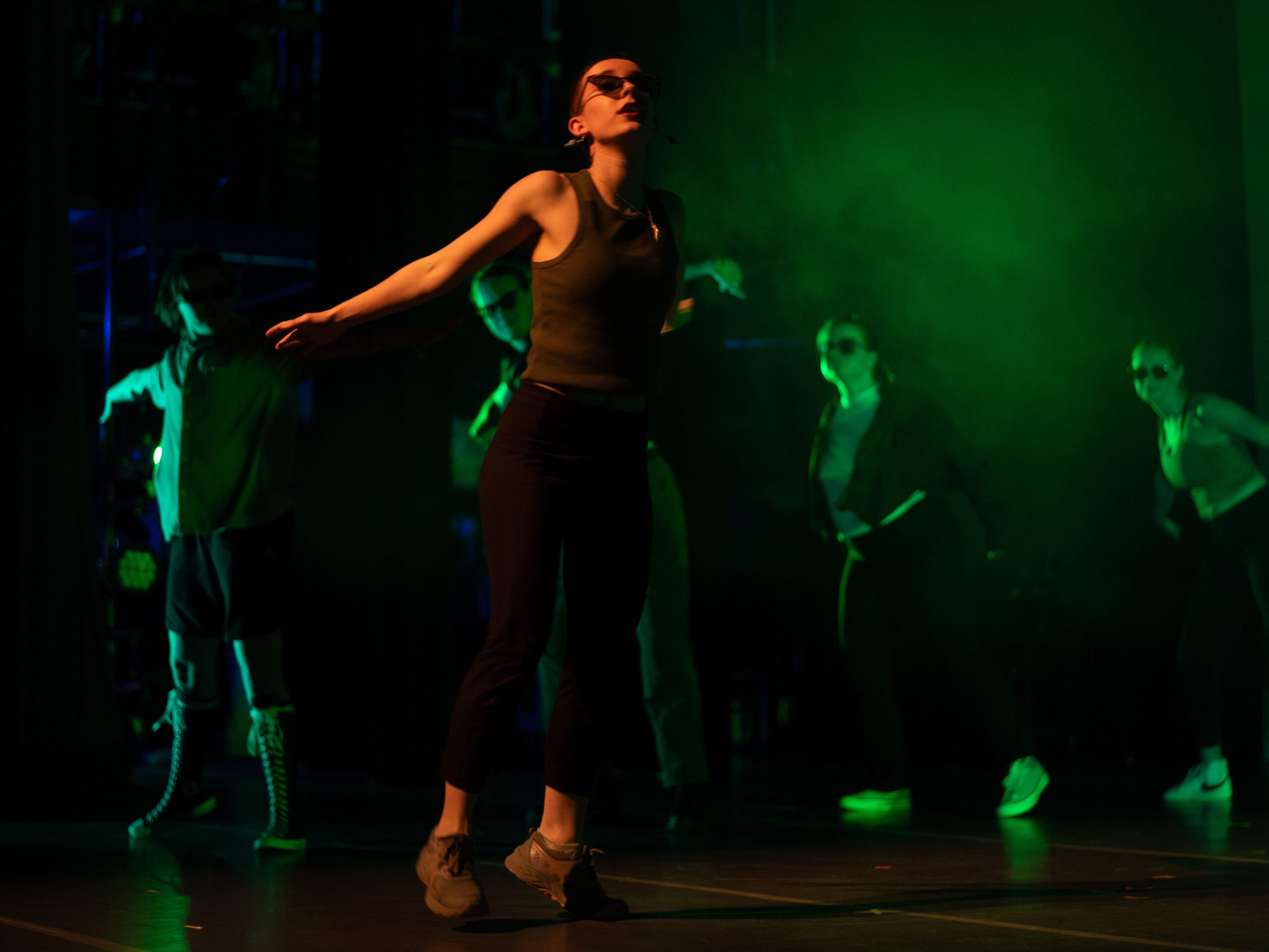 A woman turning on stage mid-dance
