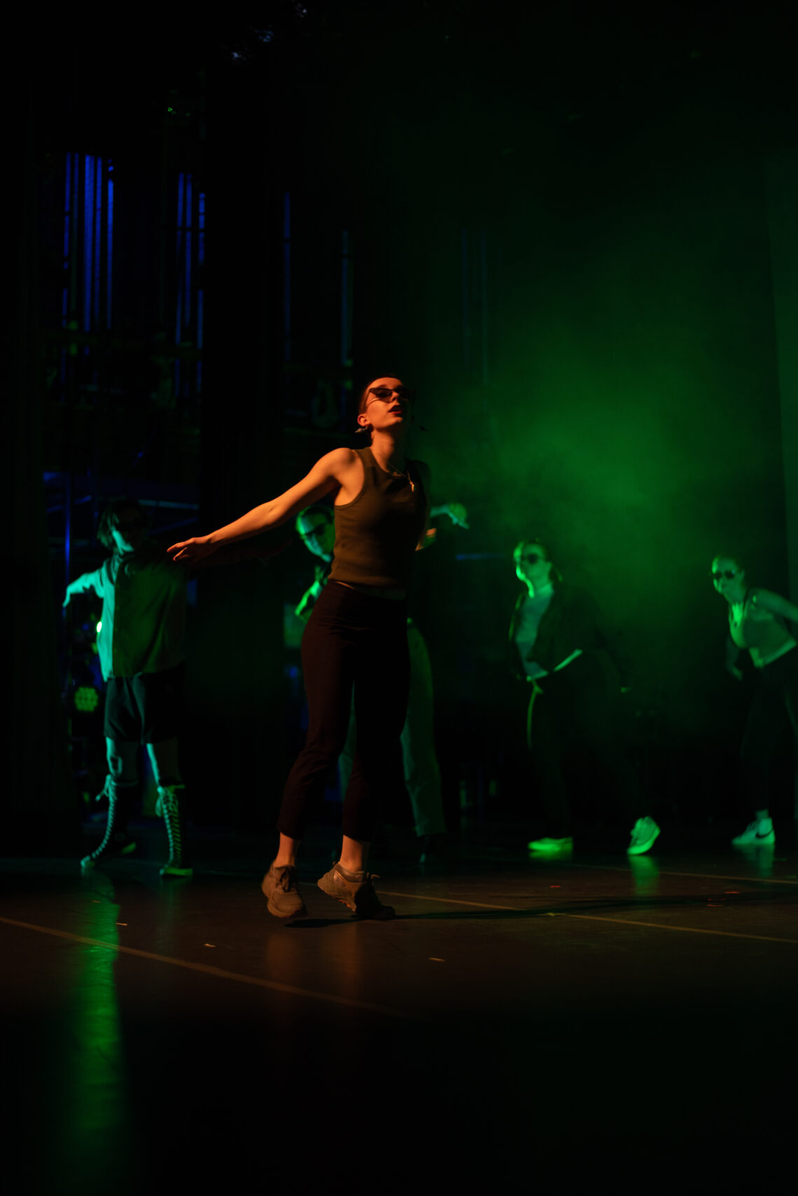 Woman dancing on stage in the spotlight, midturn.