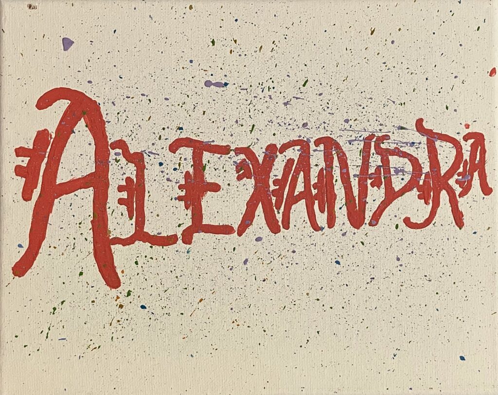 Acrylic painting on canvas of the name "Alexandra" written in pink calligraphy. There is light purple paint splattered over the name.