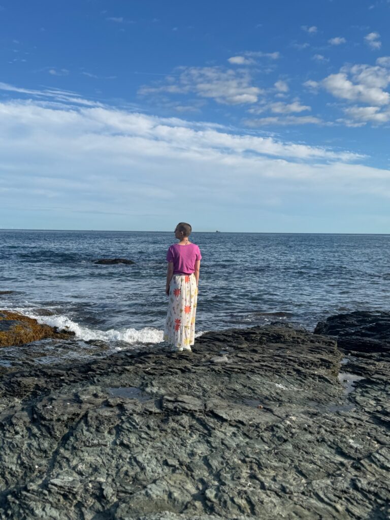 Me standing on some rocks looking out at the ocean.