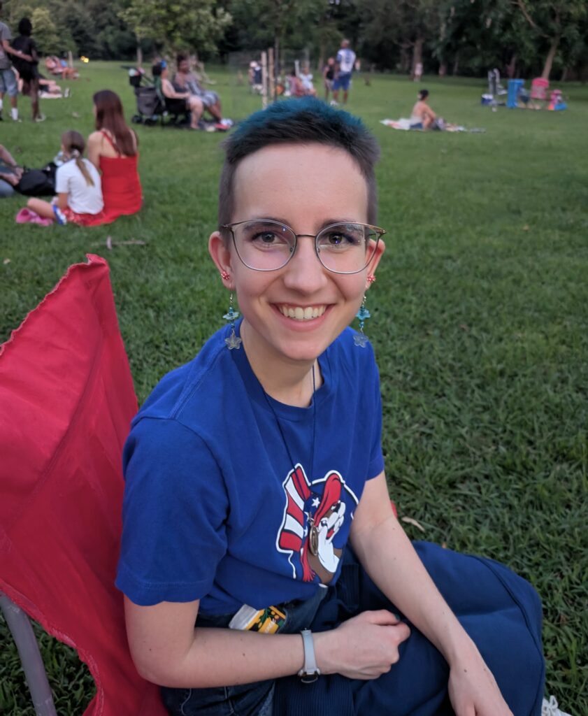 Me with a blue mohawk sitting in a lawn chair.