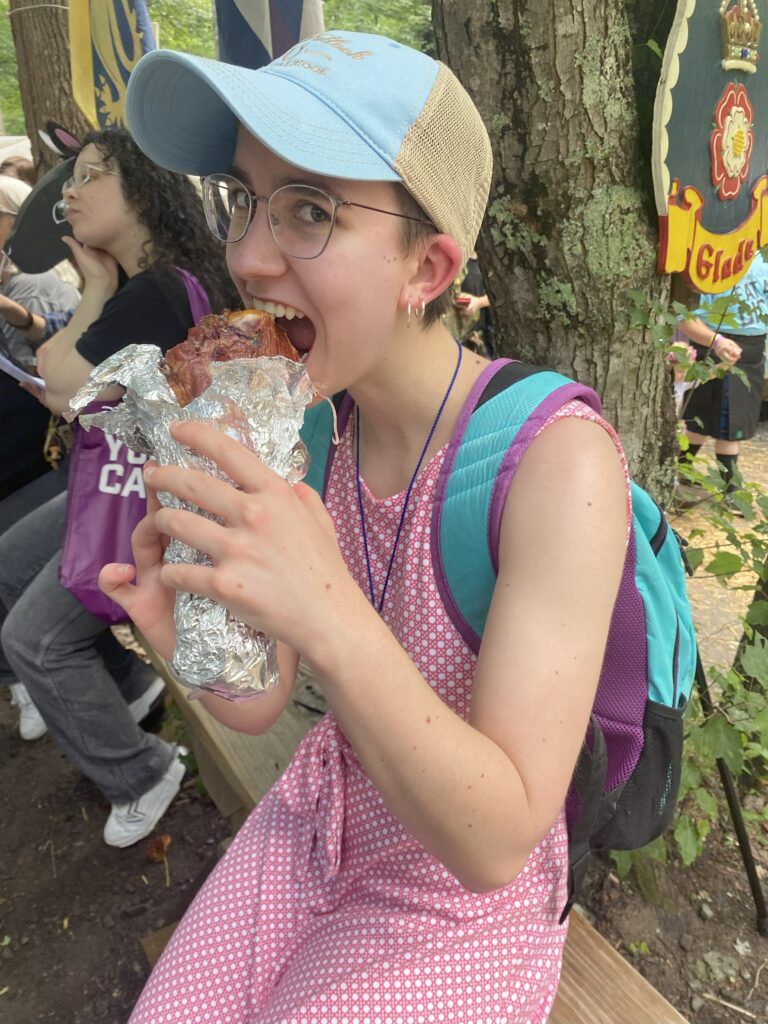 Me biting into a giant turkey leg at the Renaissance Faire.