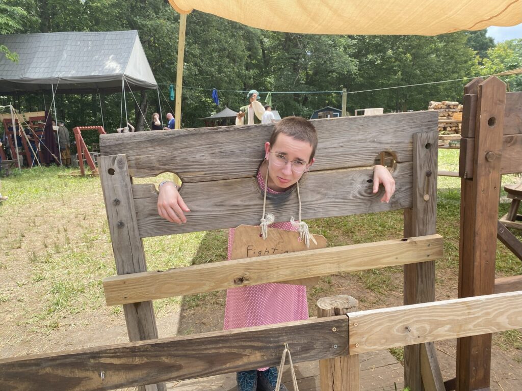 Me posing in the stocks, charged with the crime of "fighting" at the Renaissance Faire.