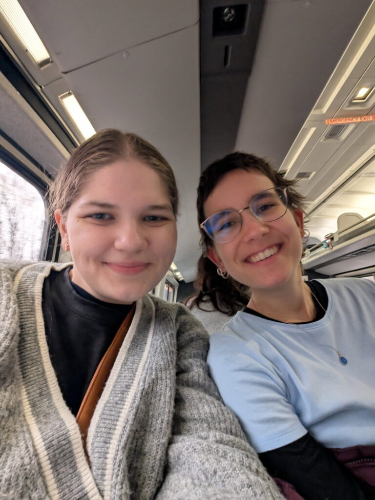 My friend and me smiling on the Amtrak.