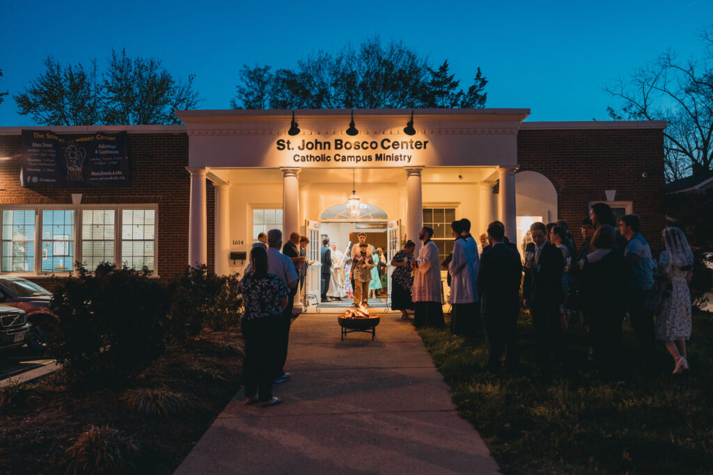 A crowd gathered around a bonfire outside of the Catholic Campus Ministry on the Easter Vigil.