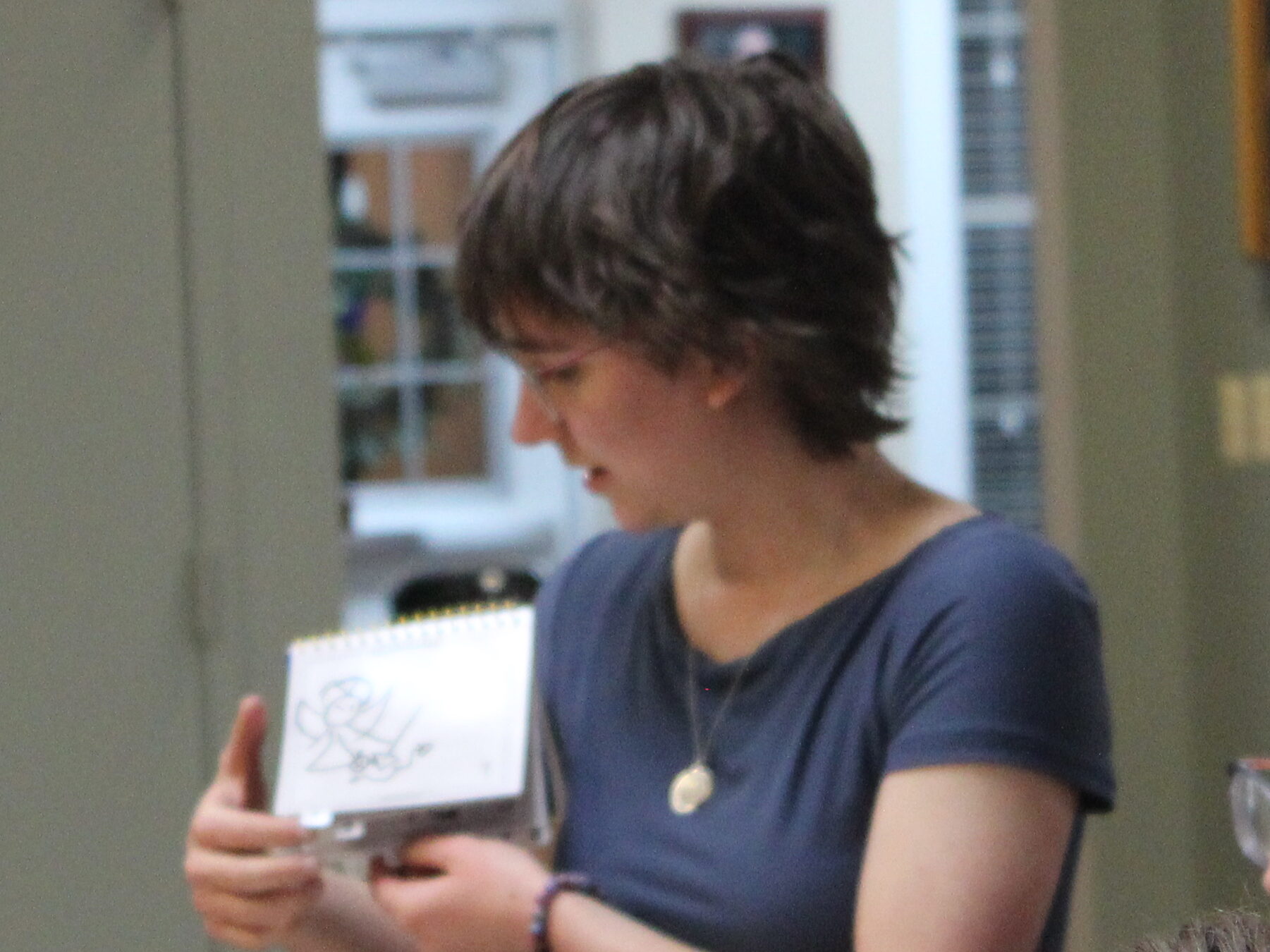 A profile view of Lexi. Her bangs just reach her eyebrows.