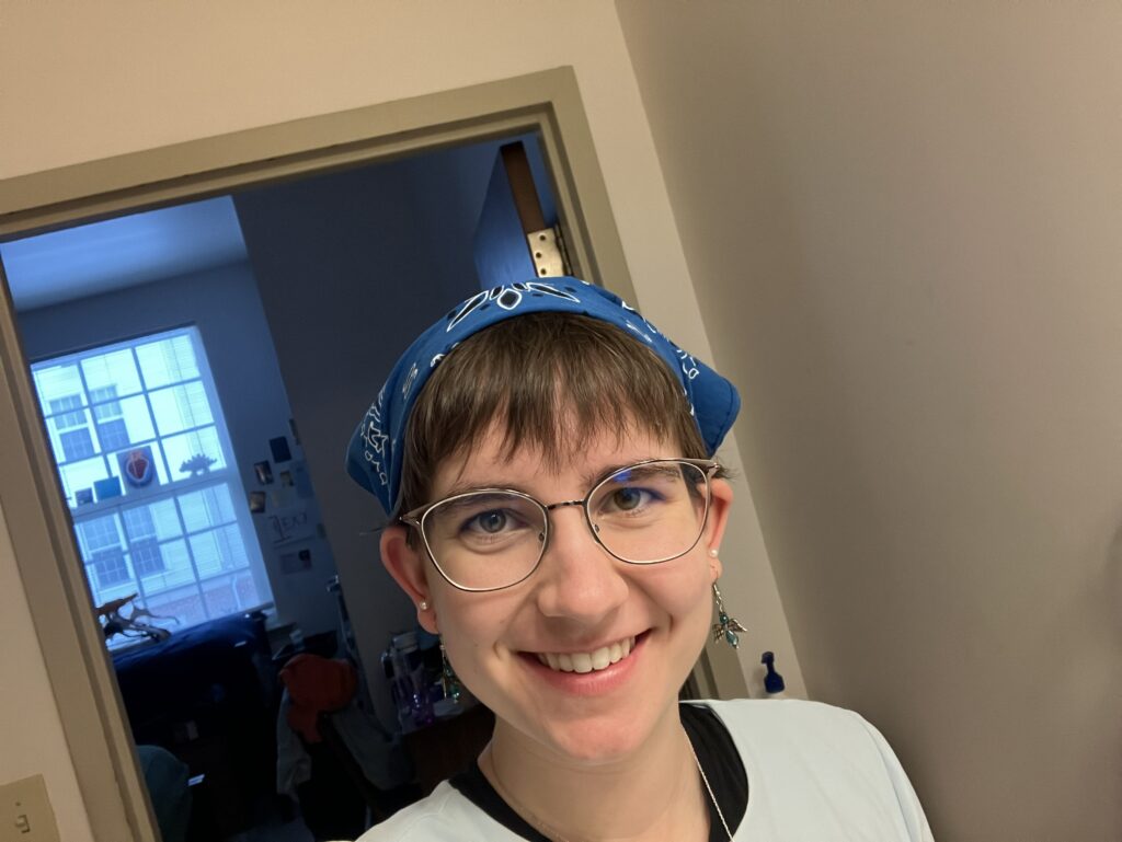 Lexi wearing a blue bandana with bangs peaking out.