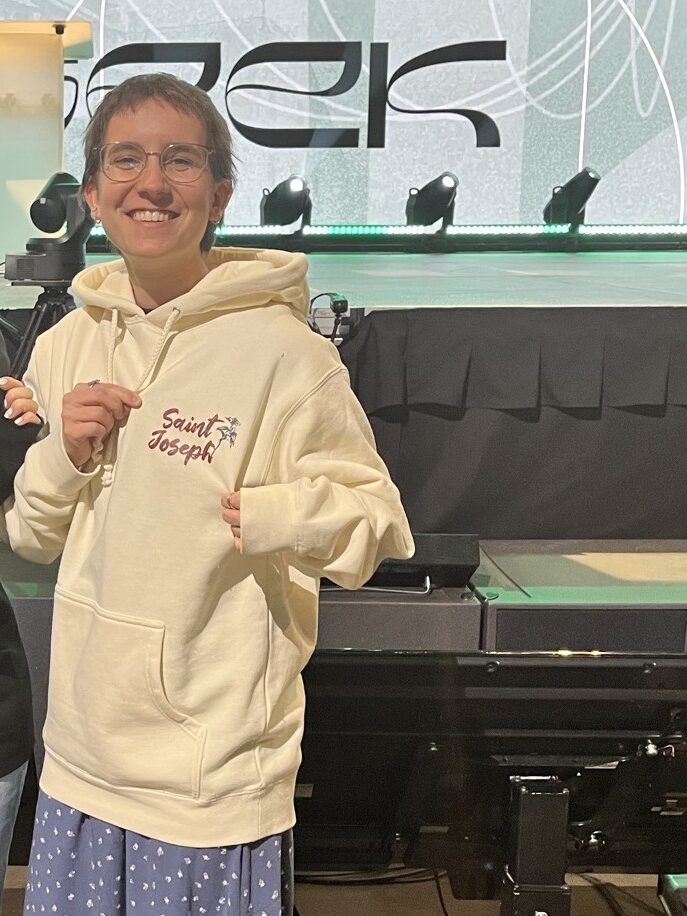 Me showing off a new hoodie that reads, "Saint Joseph" with lilies around the name.