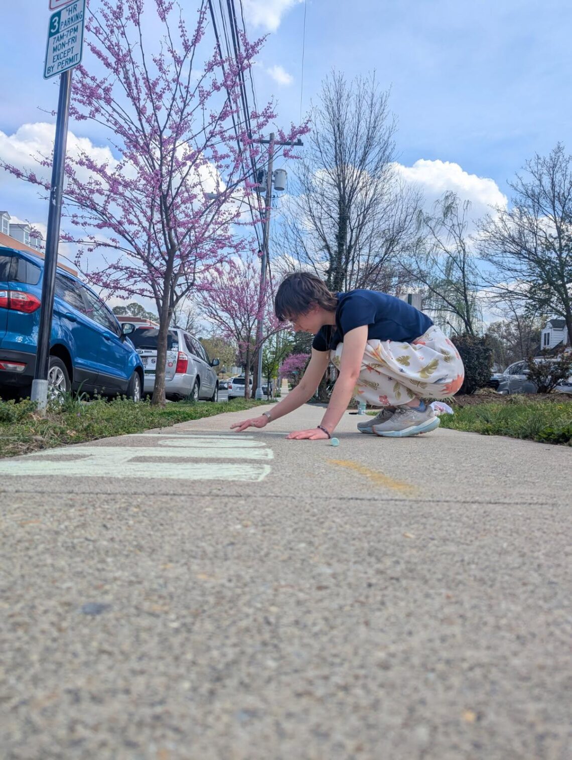 Lexi chalking in front of the CCM to advertise for Holy Week events.